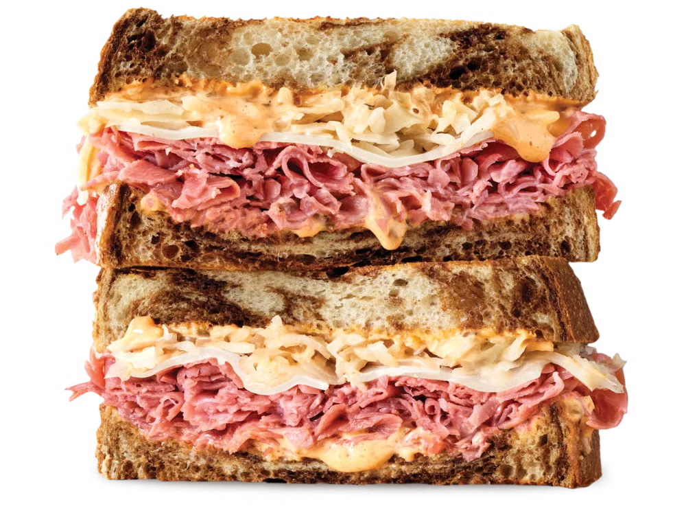Arby’s Corned Beef Reuben sandwich with corned beef, sauerkraut, Swiss cheese, and Thousand Island dressing on marble rye
