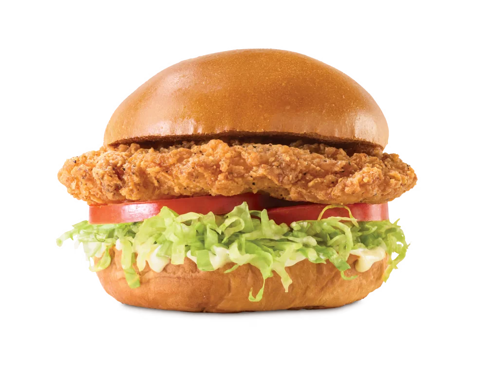 Arby’s Crispy Chicken Sandwich with breaded chicken filet, lettuce, tomato, and mayo on a toasted bun