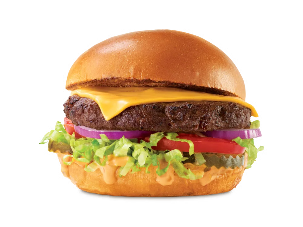 Arby’s Deluxe Burger with lettuce, tomato, pickles, and cheese on a toasted bun