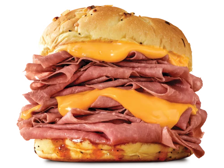 Arby’s Half Pound Beef 'n Cheddar sandwich with layers of roast beef, cheddar cheese sauce, and red ranch on a toasted onion roll
