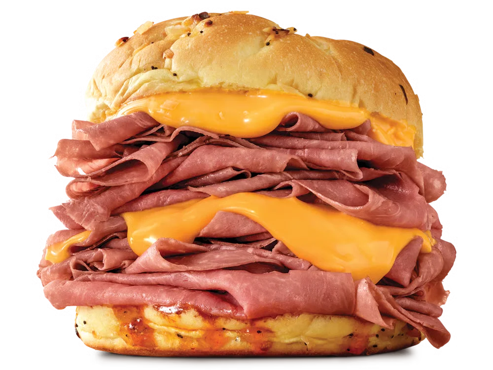 Arby’s Half Pound Beef 'n Cheddar sandwich with layers of roast beef, cheddar cheese sauce, and red ranch on a toasted onion roll