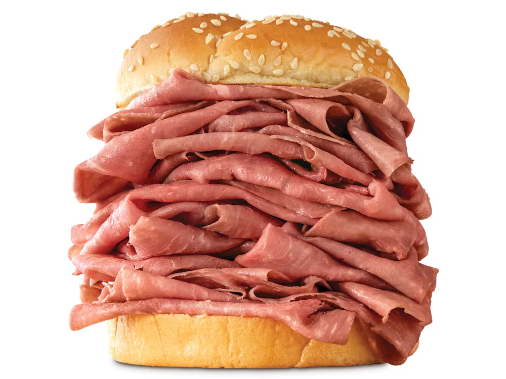 Arby’s Half Pound Roast Beef sandwich with extra layers of sliced roast beef on a sesame seed bun
