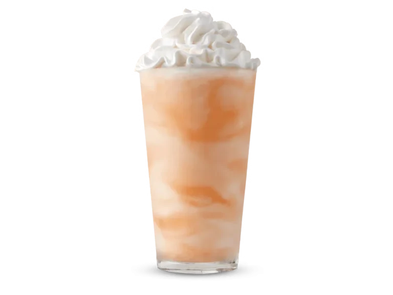 Arby’s Orange Cream Shake in a clear cup with whipped topping