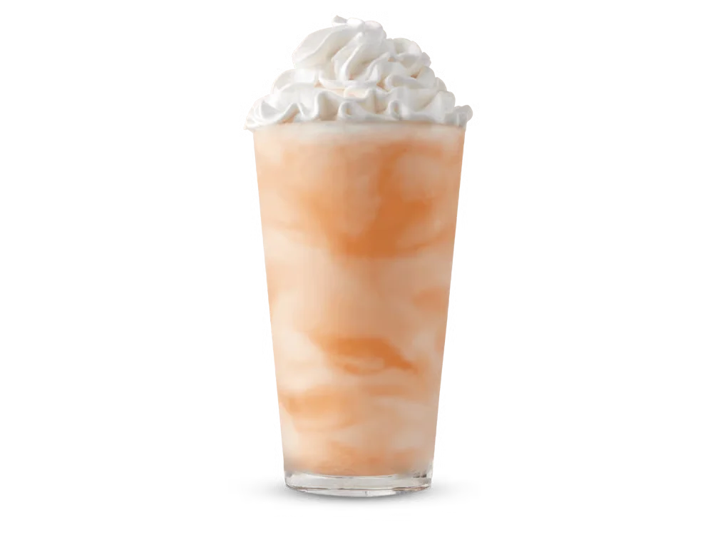 Arby’s Orange Cream Shake in a clear cup with whipped topping
