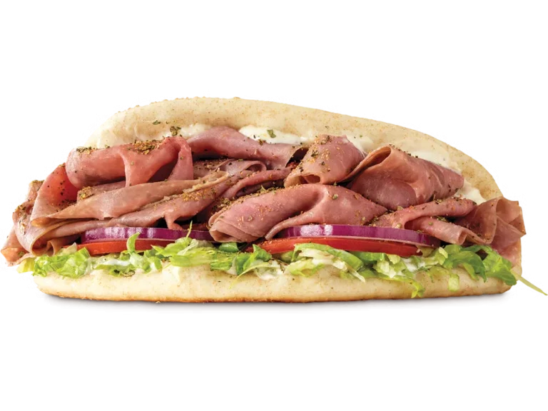 Arby’s Roast Beef Gyro with thin-sliced roast beef, tzatziki sauce, lettuce, tomato, onion, and pita bread