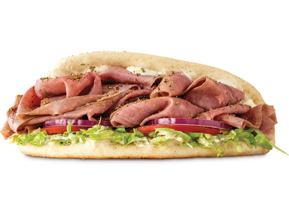 Arby’s Roast Beef Gyro with thin-sliced roast beef, tzatziki sauce, lettuce, tomato, onion, and pita bread