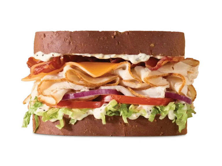 Arby’s Roast Turkey Ranch & Bacon Sandwich with turkey, peppercorn ranch, bacon, cheese, lettuce, and tomato on a toasted roll