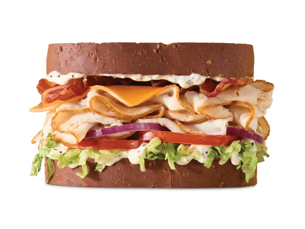 Arby’s Roast Turkey Ranch & Bacon Sandwich with turkey, peppercorn ranch, bacon, cheese, lettuce, and tomato on a toasted roll
